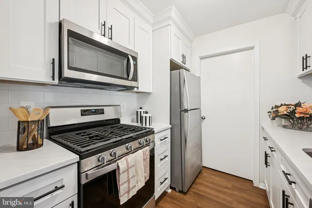 a kitchen with stainless steel appliances a stove a microwave and a refrigerator