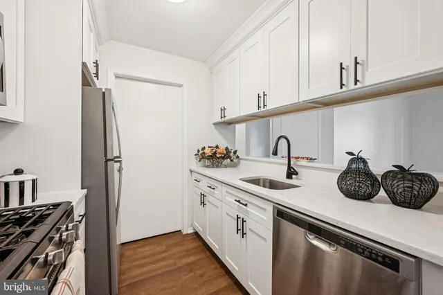 a kitchen with stainless steel appliances a sink and cabinets