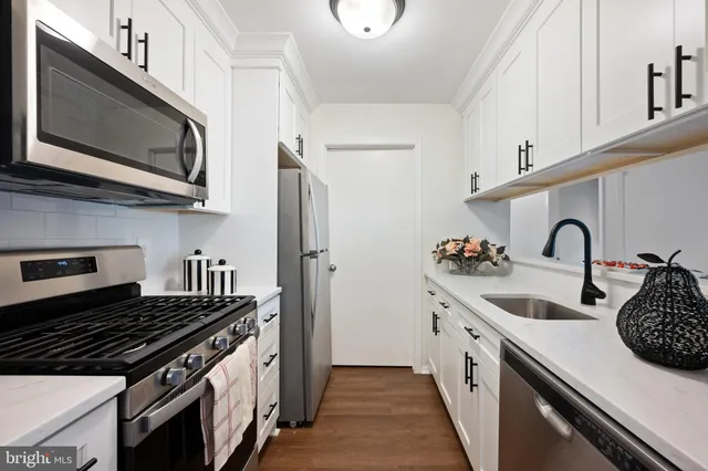 a kitchen with stainless steel appliances granite countertop a stove and a sink