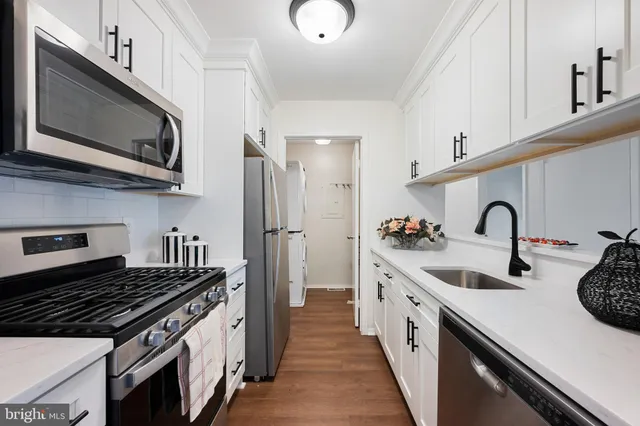 a kitchen with stainless steel appliances granite countertop a stove and a sink