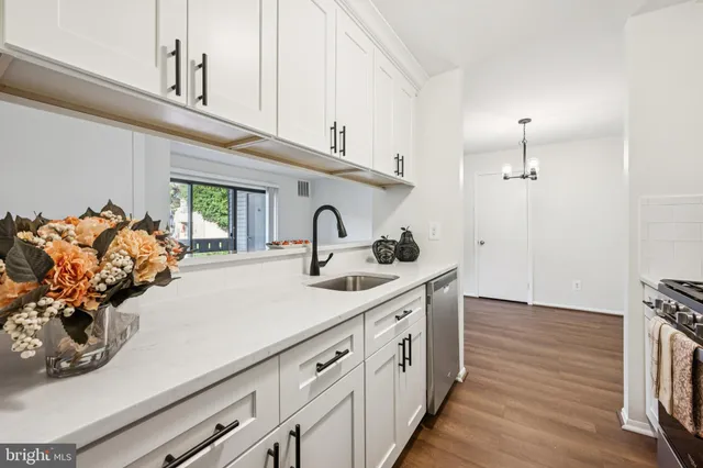 a kitchen with sink stove and cabinets