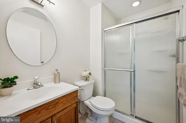 a bathroom with a sink toilet and a mirror