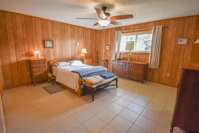 a spacious bedroom with a bed and a table in it