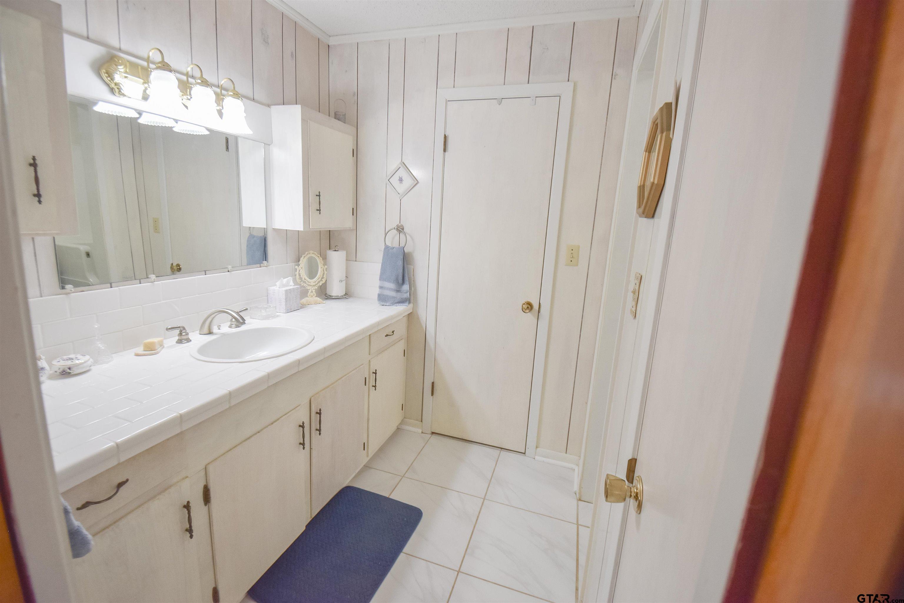 355 West Sugar Hill Road Reklaw, TX 75784 - Photo 18 of 38 a bathroom with a sink a mirror and a shower