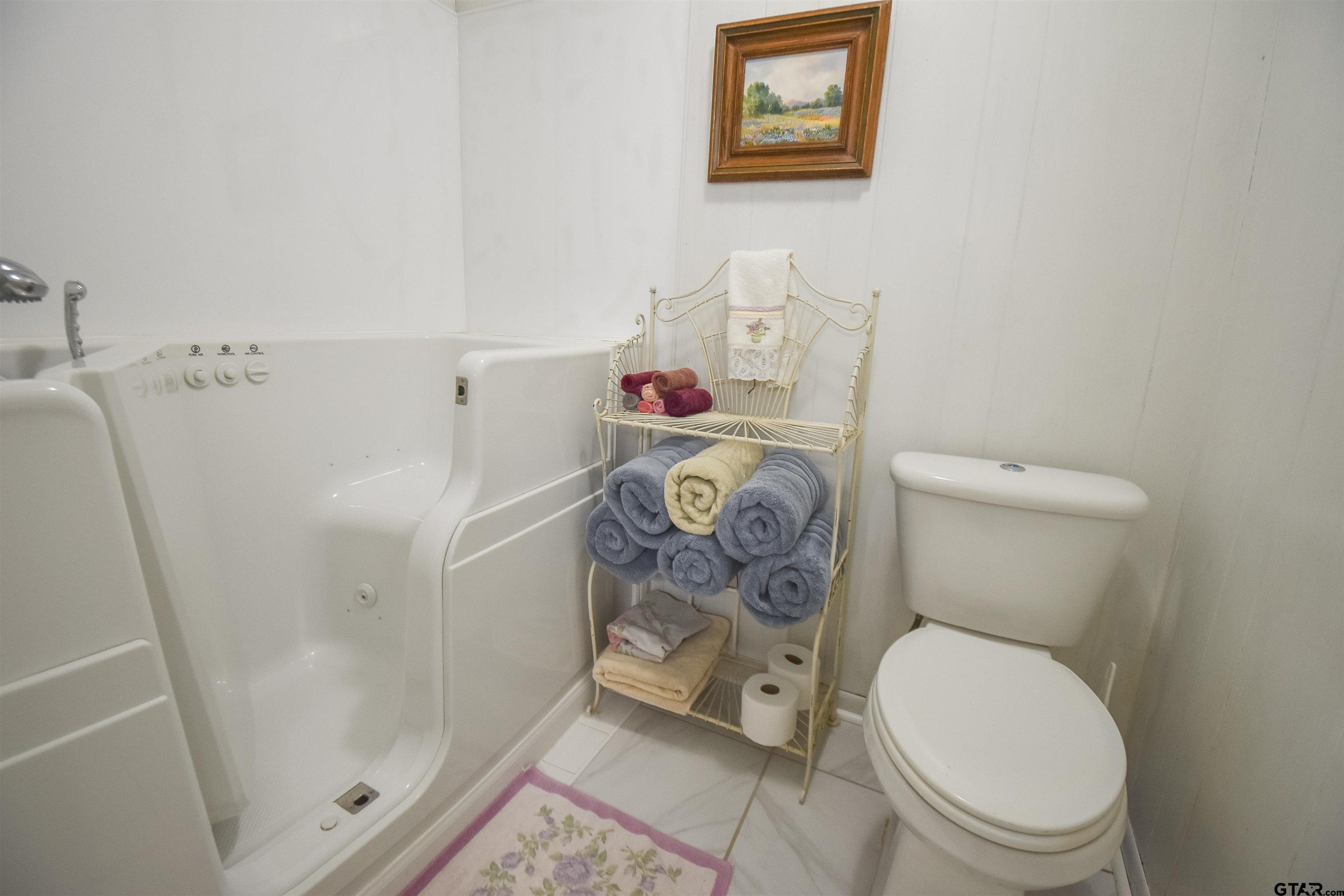 355 West Sugar Hill Road Reklaw, TX 75784 - Photo 19 of 38 a bathroom with a toilet and a shower