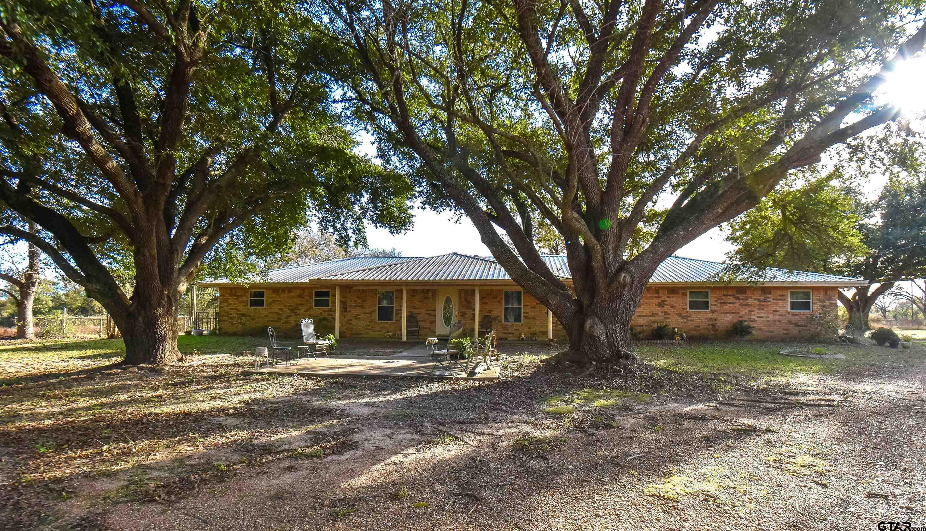 355 West Sugar Hill Road Reklaw, TX 75784 - Photo 2 of 38 a view of a house with a large tree and a big yard