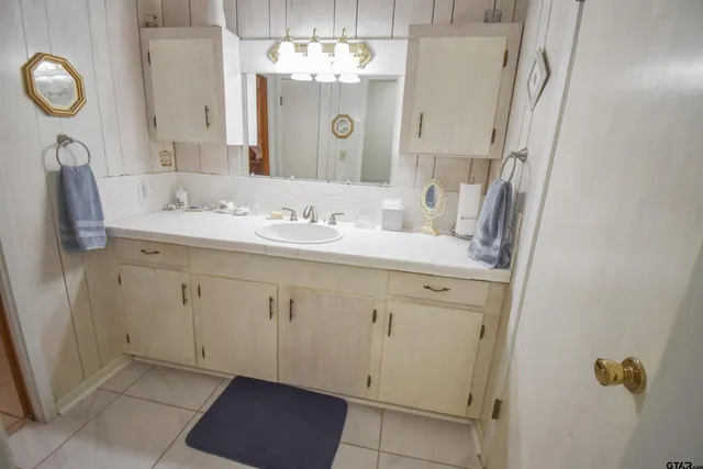 a bathroom with a double vanity sink mirror and