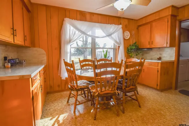 a dining room with furniture and a window