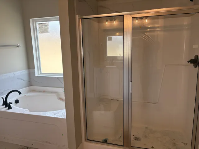 a bathroom with a bathtub and shower