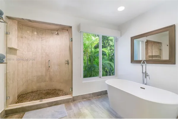 a bathroom with a bathtub and a shower