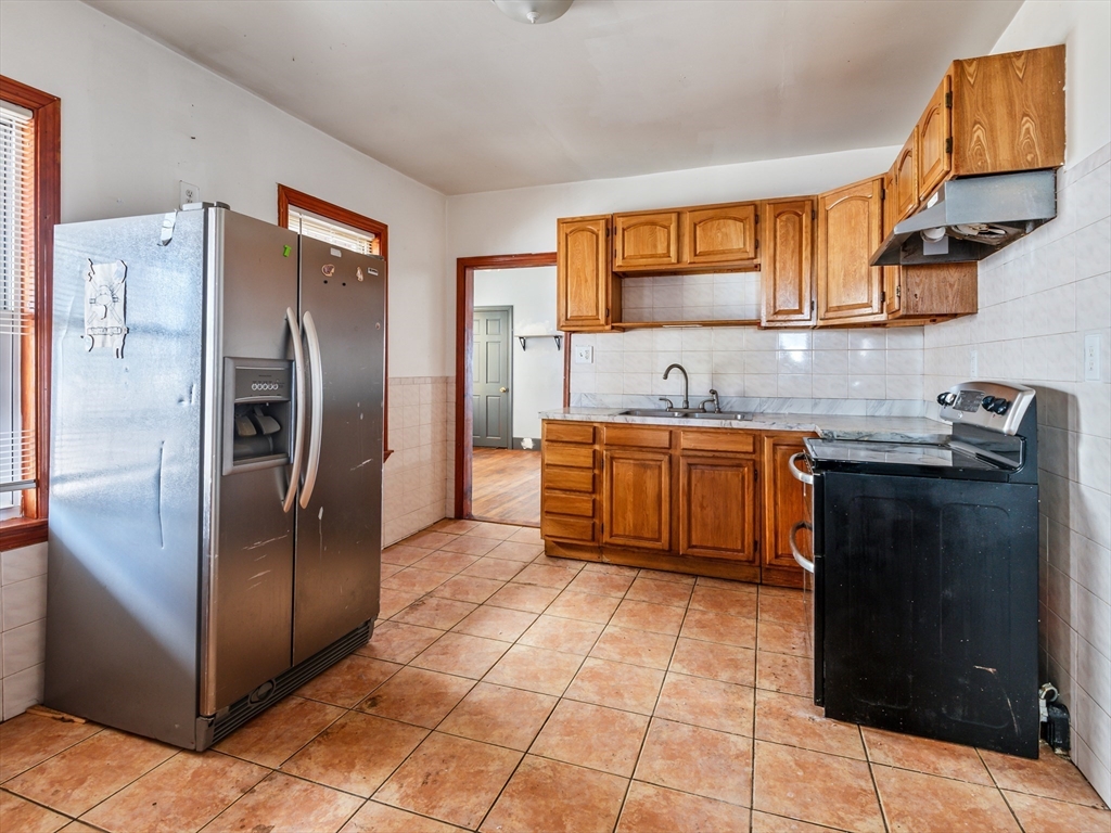 549 Cambridge Street Worcester, MA 01610 - Photo 11 of 22 a kitchen with stainless steel appliances granite countertop a refrigerator and a sink