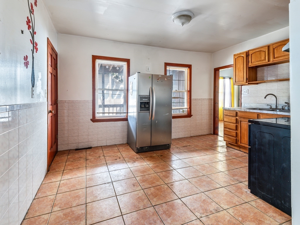 549 Cambridge Street Worcester, MA 01610 - Photo 12 of 22 a view of a refrigerator in kitchen and an empty room