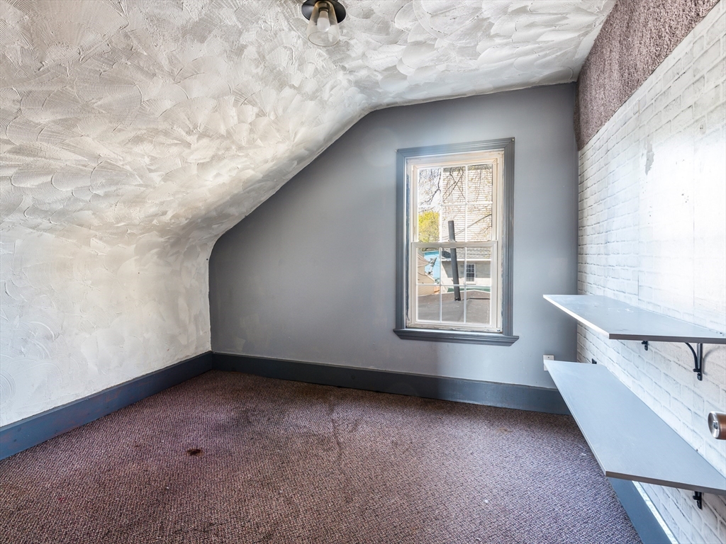 549 Cambridge Street Worcester, MA 01610 - Photo 19 of 22 a view of an empty room with a window