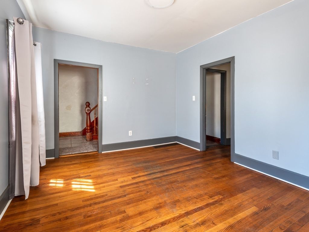 549 Cambridge Street Worcester, MA 01610 - Photo 6 of 22 a view of a room with wooden floor and a bathroom