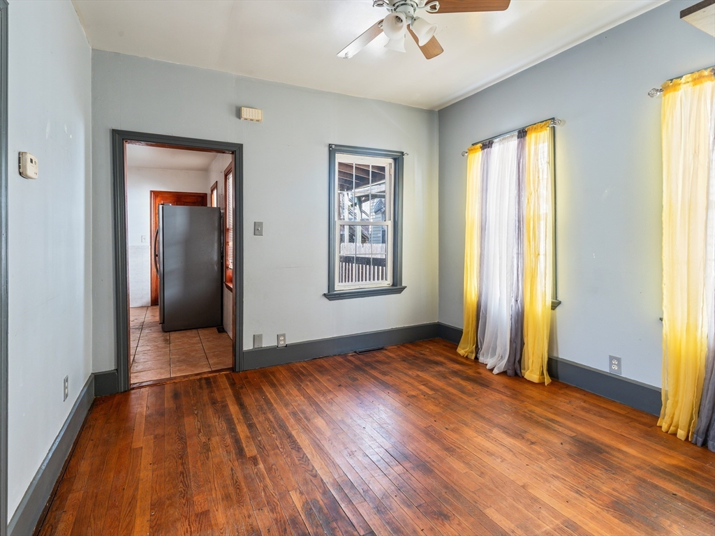 549 Cambridge Street Worcester, MA 01610 - Photo 7 of 22 an empty room with wooden floor and windows