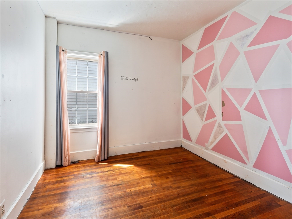 549 Cambridge Street Worcester, MA 01610 - Photo 9 of 22 an empty room with wooden floor and windows