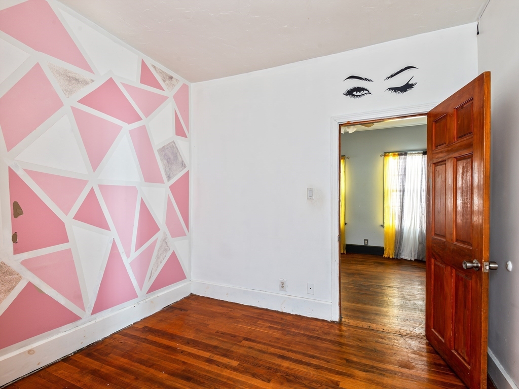 549 Cambridge Street Worcester, MA 01610 - Photo 10 of 22 a view of a room with wooden floor and a ceiling fan