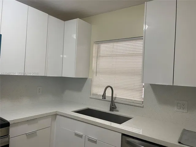 a kitchen with a sink and cabinets