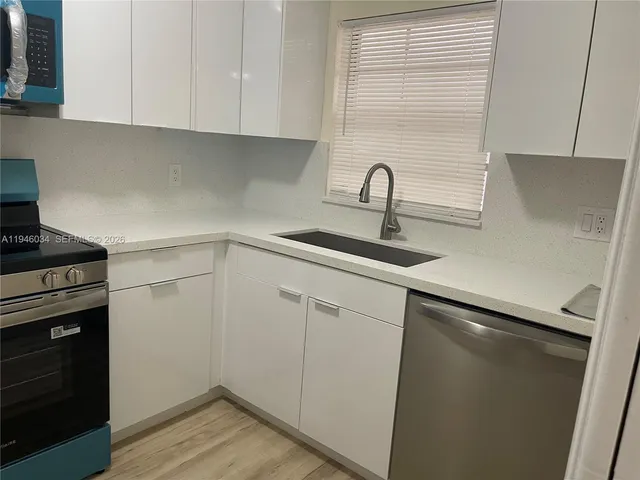 a kitchen with a sink and cabinets
