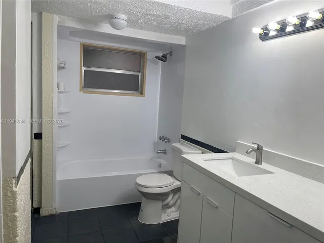 a bathroom with a toilet a sink and bathtub