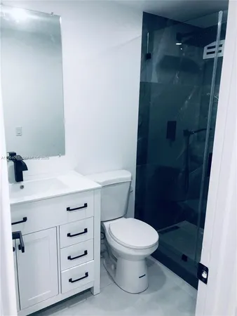 a bathroom with a toilet a sink and shower