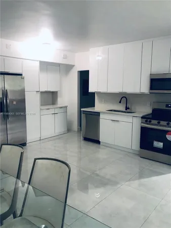 a kitchen with a sink cabinets and stainless steel appliances