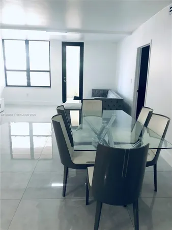 a view of a dining room with furniture and window
