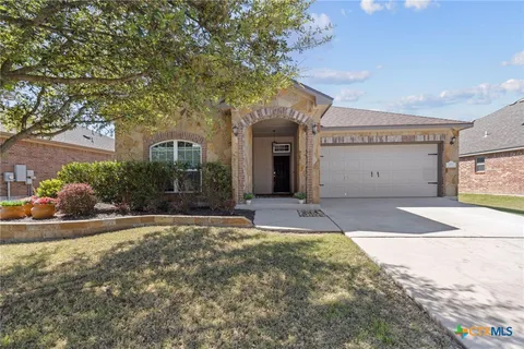 a view of a house with a yard and garage