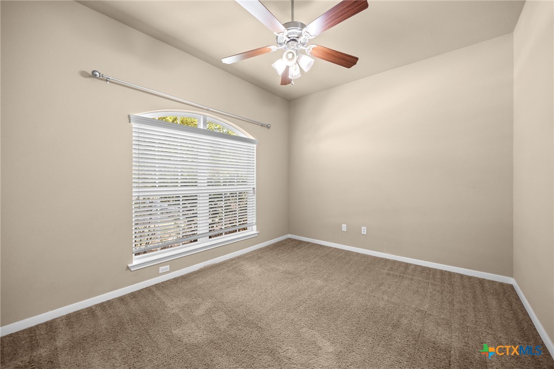 517 Coventry Drive Temple, TX 76502 - Photo 11 of 34 an empty room with windows and fan