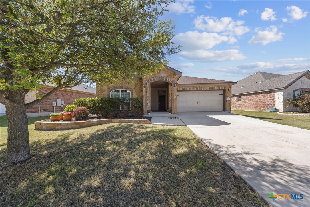 517 Coventry Drive Temple, TX 76502 - Photo 2 of 34 a view of a house with a yard and garage
