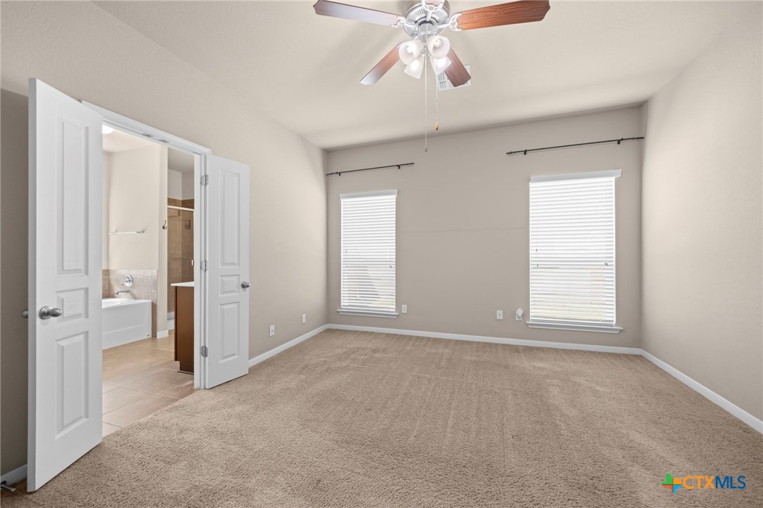 517 Coventry Drive Temple, TX 76502 - Photo 22 of 34 an empty room with fan and windows