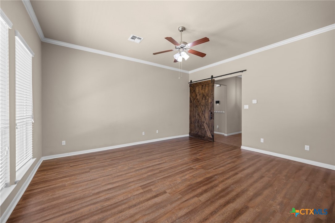 517 Coventry Drive Temple, TX 76502 - Photo 6 of 34 a view of an empty room with wooden floor and a window