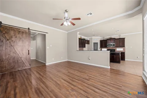 a view of a kitchen with a microwave and wooden floor