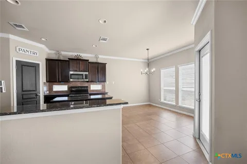 a kitchen with stainless steel appliances a sink a stove a microwave and cabinets