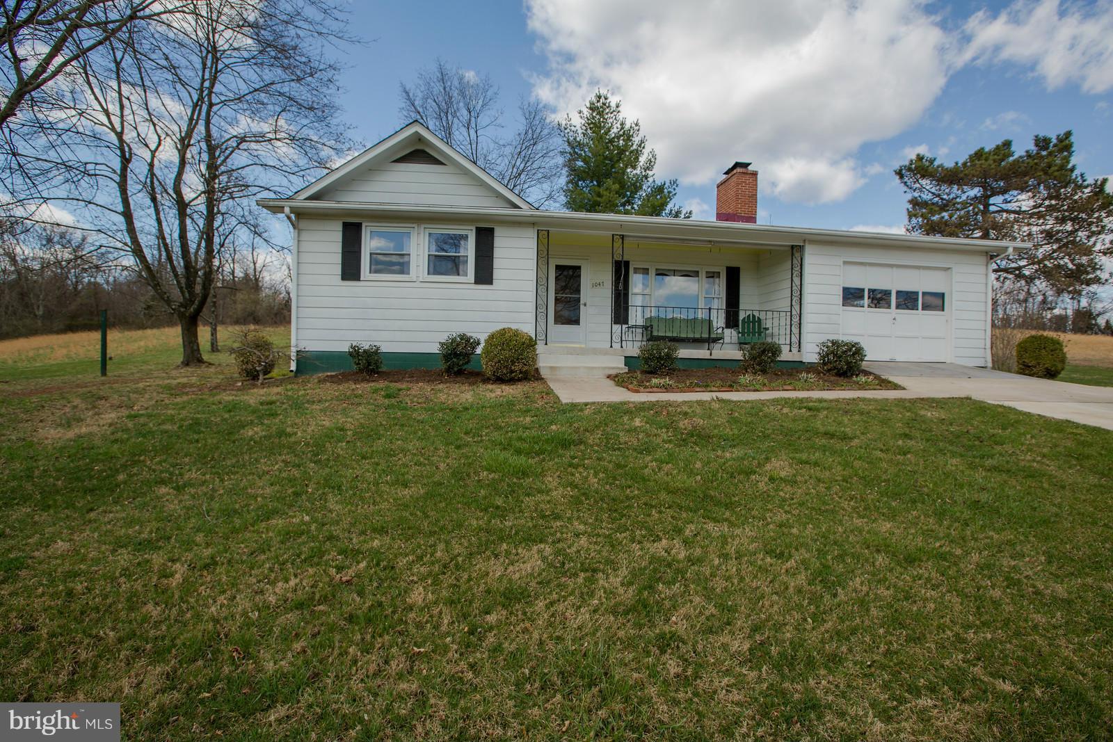 1047 New Hope Road Cross Junction, VA 22625 - Photo 1 of 27 a front view of a house with a yard and trees