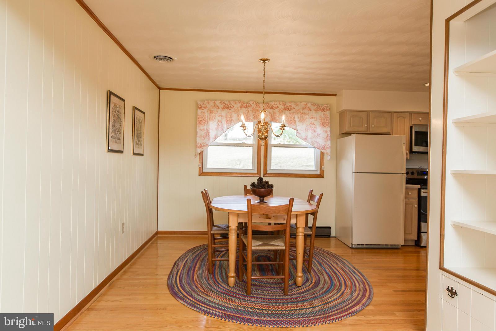 1047 New Hope Road Cross Junction, VA 22625 - Photo 11 of 27 a view of a dining room with furniture window and wooden floor