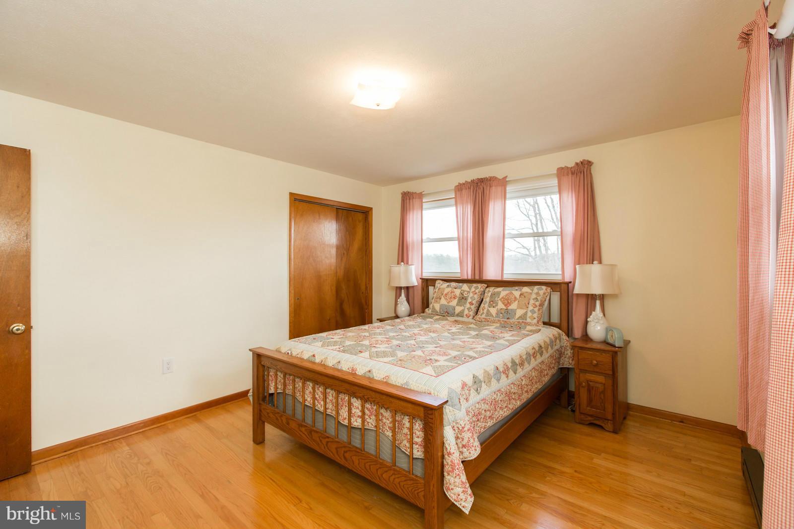 1047 New Hope Road Cross Junction, VA 22625 - Photo 12 of 27 a bed sitting in a spacious bedroom next to a window