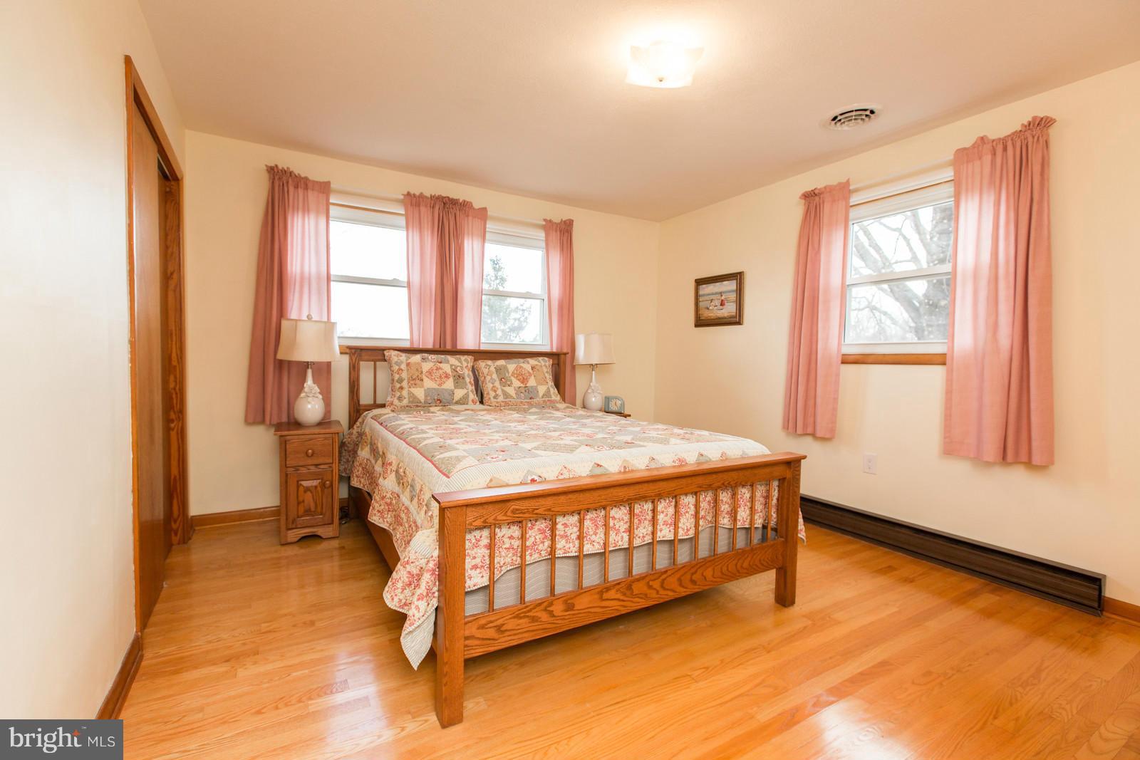 1047 New Hope Road Cross Junction, VA 22625 - Photo 13 of 27 a bed sitting in a bedroom next to a window