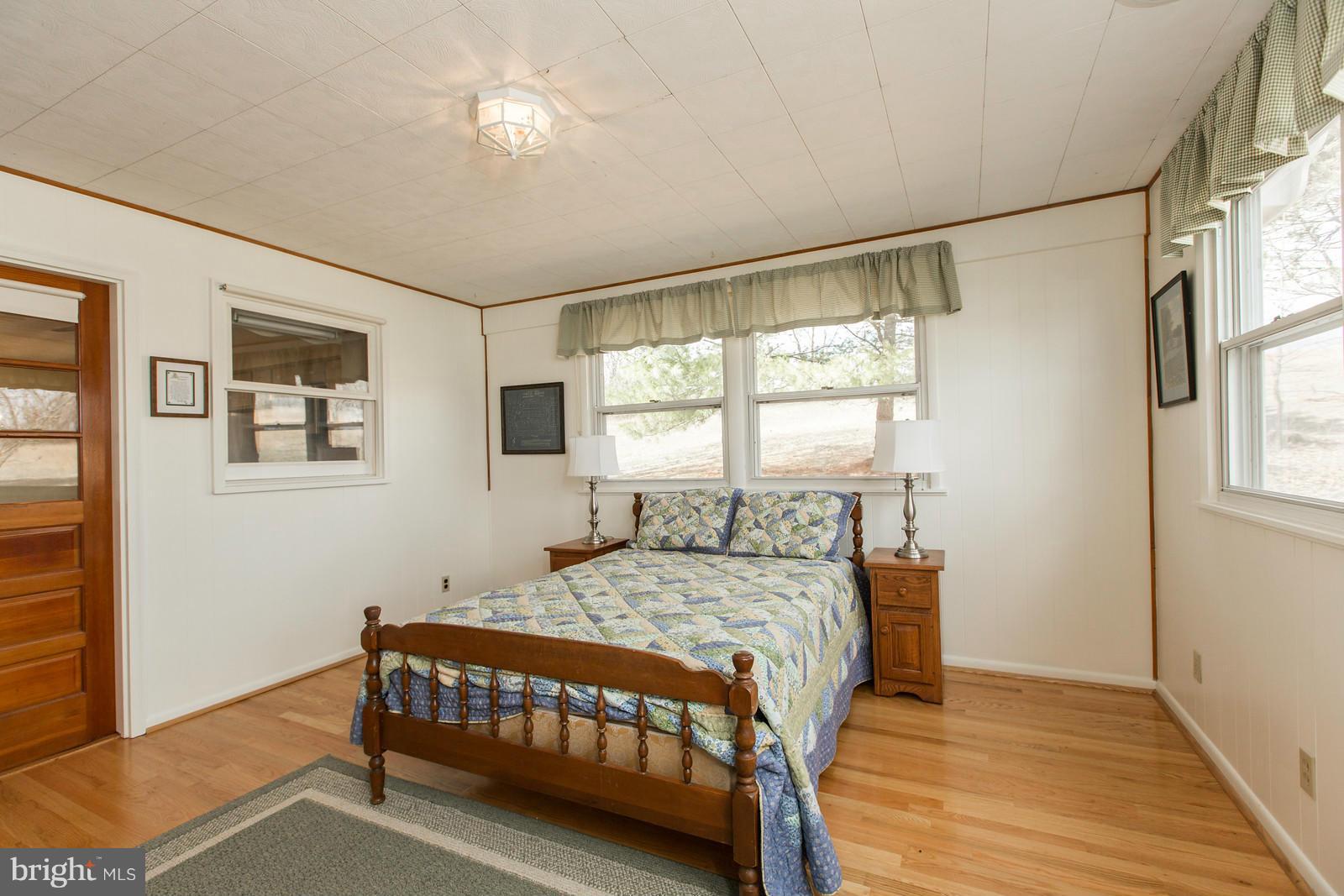 1047 New Hope Road Cross Junction, VA 22625 - Photo 16 of 27 a bedroom with a bed window and a table