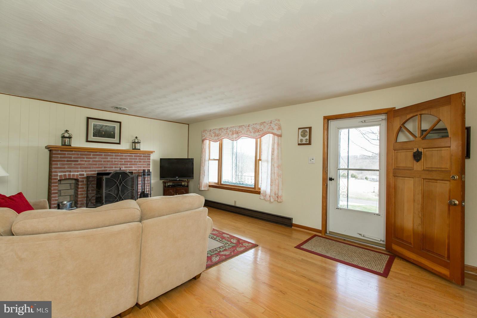 1047 New Hope Road Cross Junction, VA 22625 - Photo 4 of 27 a living room with furniture fireplace and wooden floor