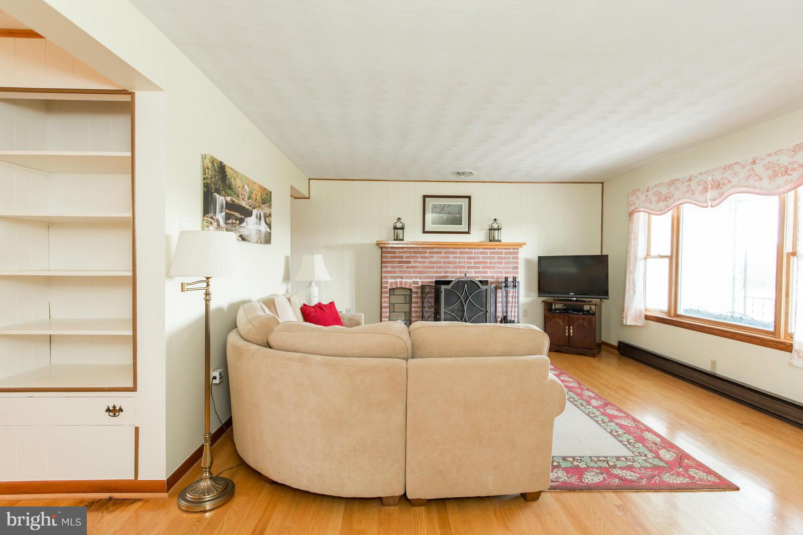 1047 New Hope Road Cross Junction, VA 22625 - Photo 6 of 27 a living room with furniture a flat screen tv and a fireplace