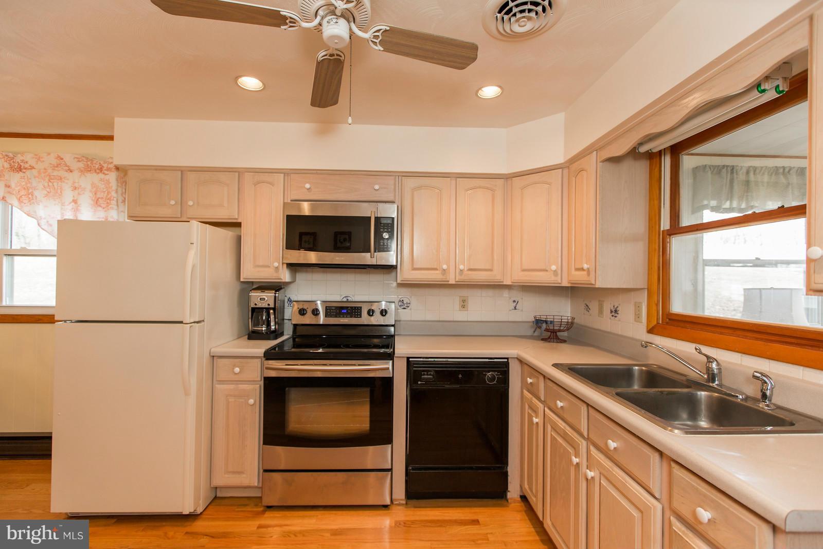 1047 New Hope Road Cross Junction, VA 22625 - Photo 8 of 27 a kitchen with a sink cabinets stainless steel appliances and a window