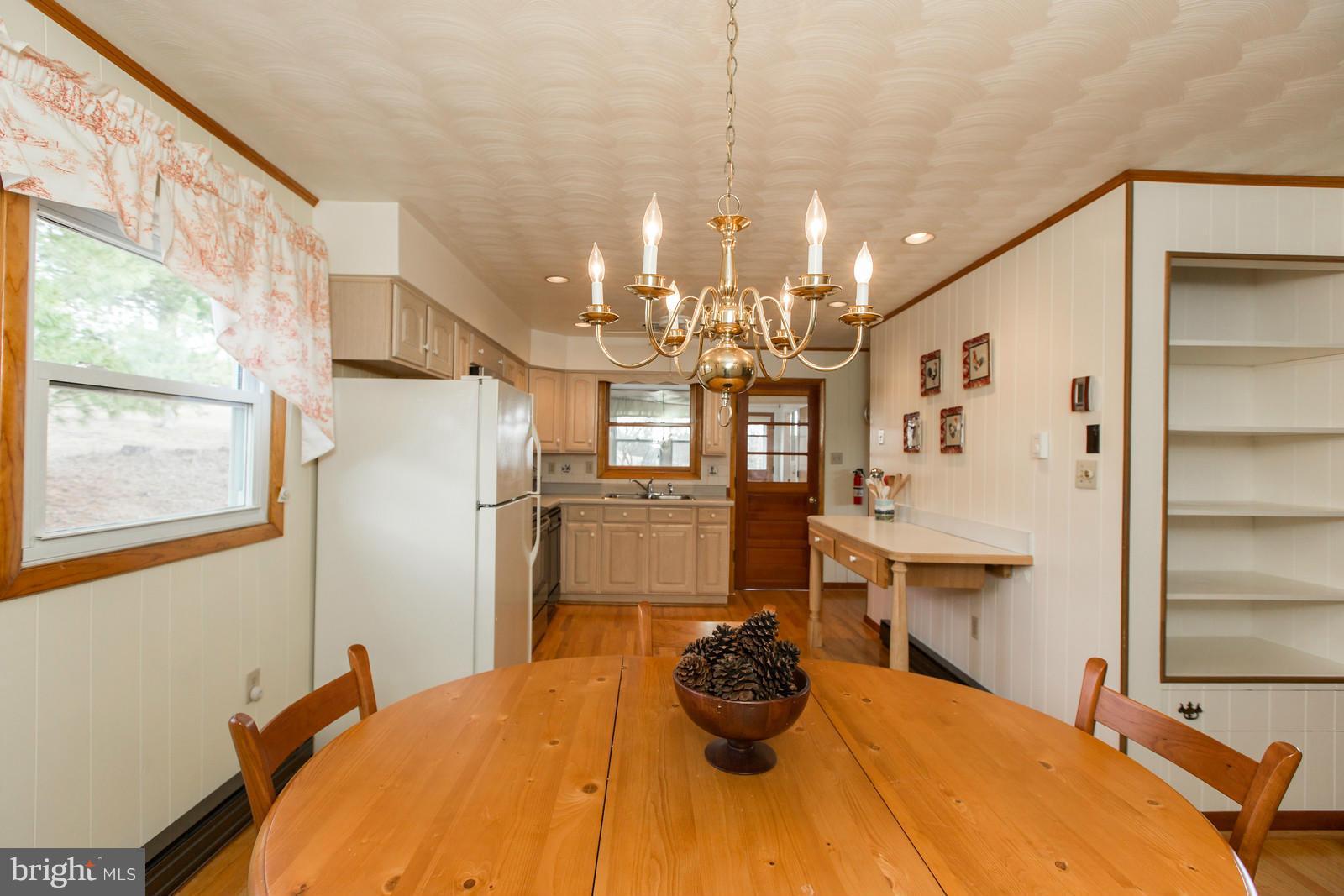 1047 New Hope Road Cross Junction, VA 22625 - Photo 9 of 27 a bedroom with a bed and a chandelier