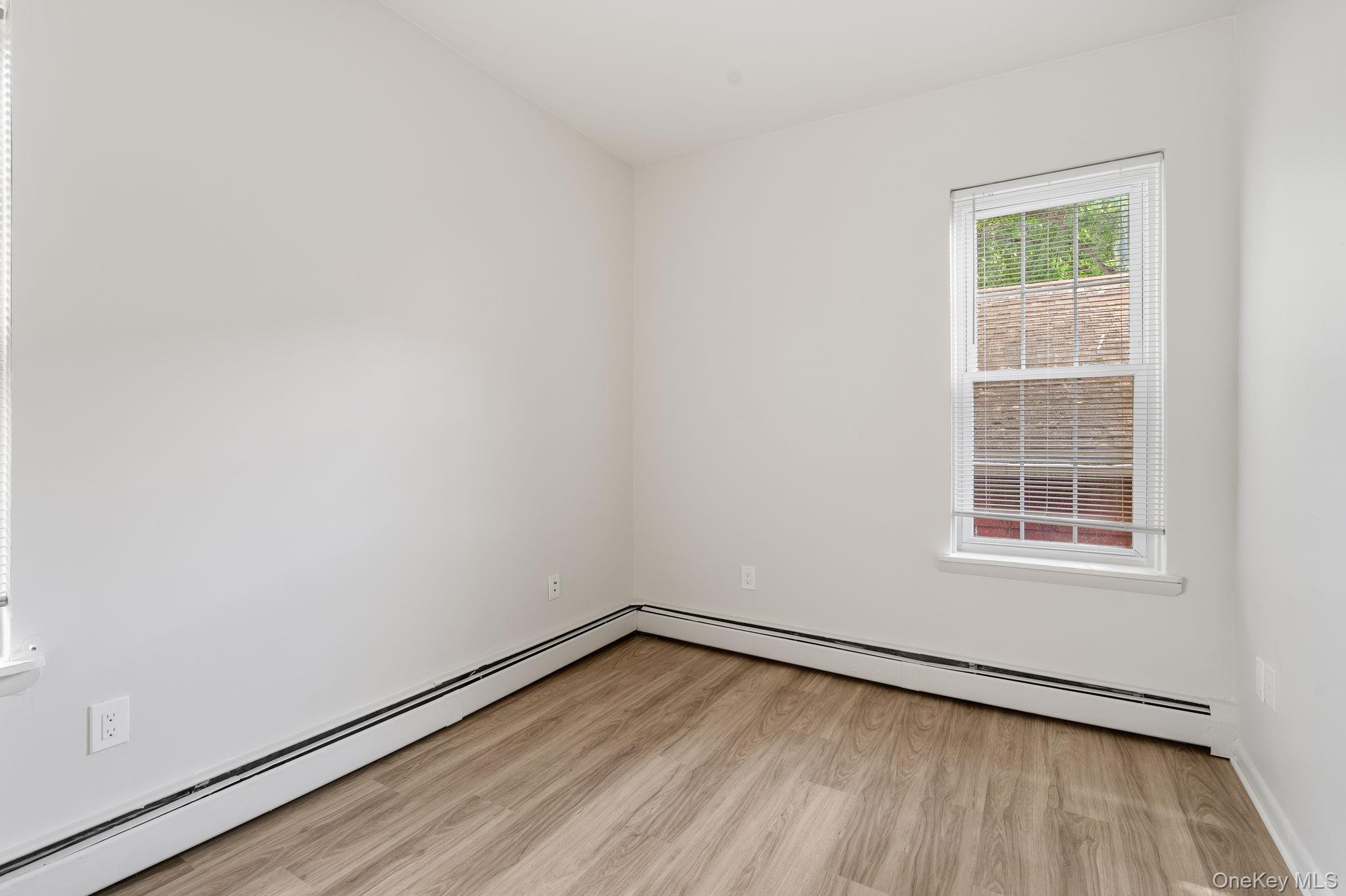 32 North Bridge Street Poughkeepsie, NY 12601 - Photo 8 of 19 an empty room with wooden floor and windows