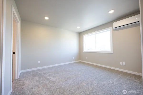 an empty room with closet and a bathroom