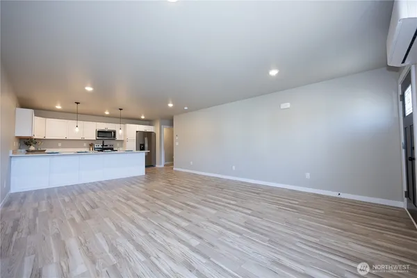 a view of kitchen with kitchen island and stainless steel appliances