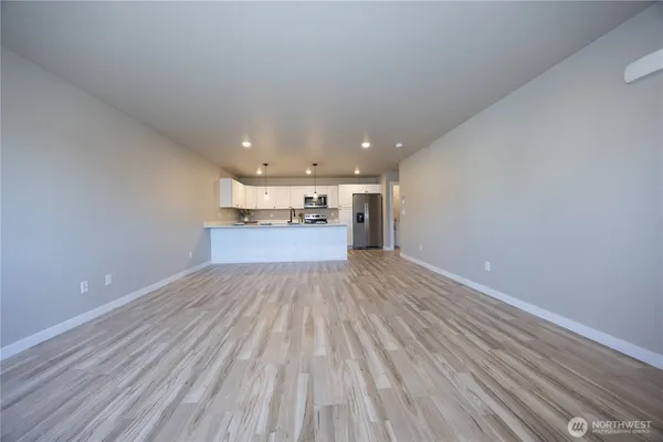 a view of empty room with wooden floor