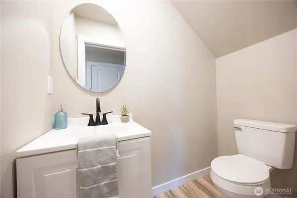 a bathroom with a toilet a sink and a mirror