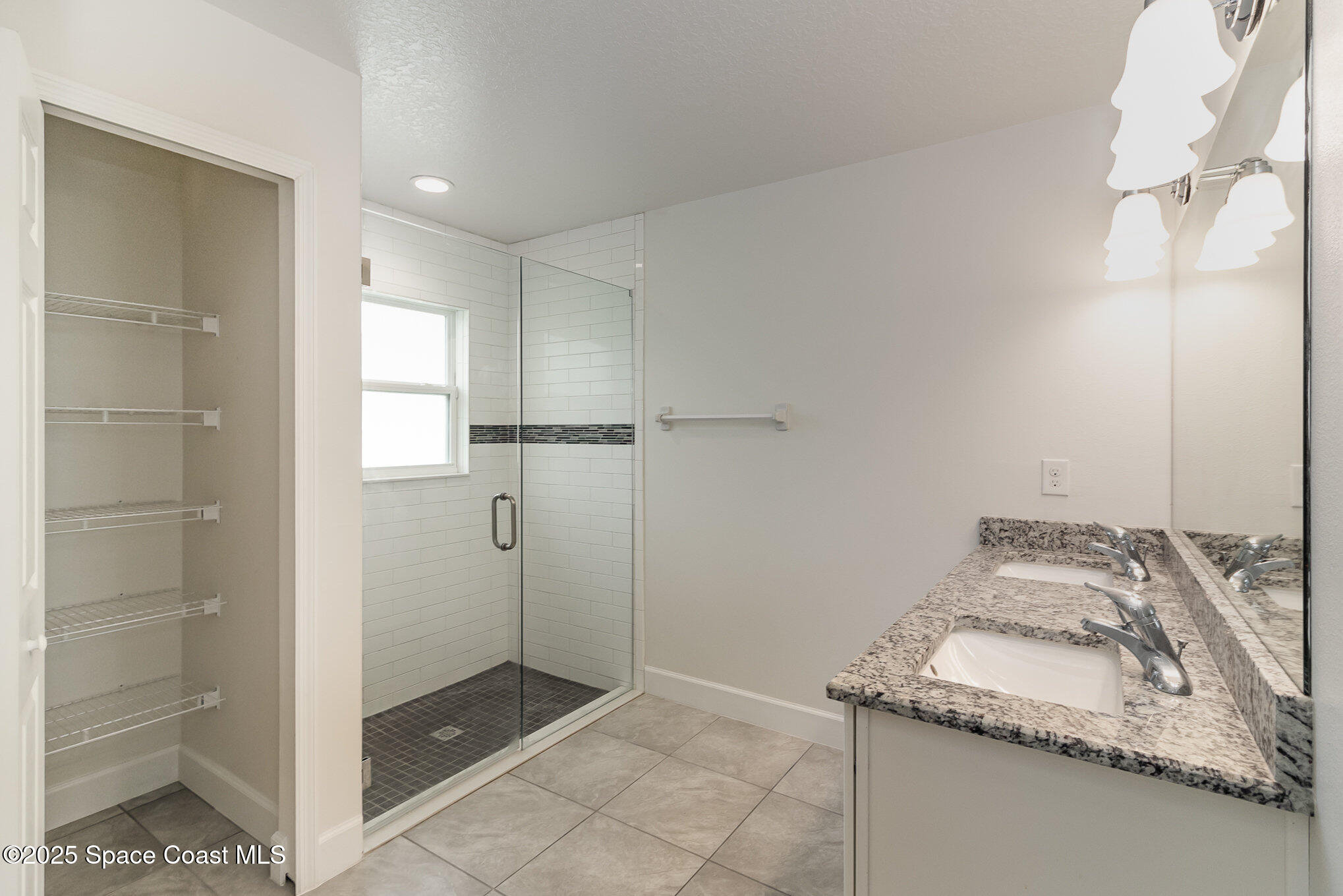 691 Belvedere Road Northwest Palm Bay, FL 32907 - Photo 12 of 26 a bathroom with a granite countertop sink and a shower