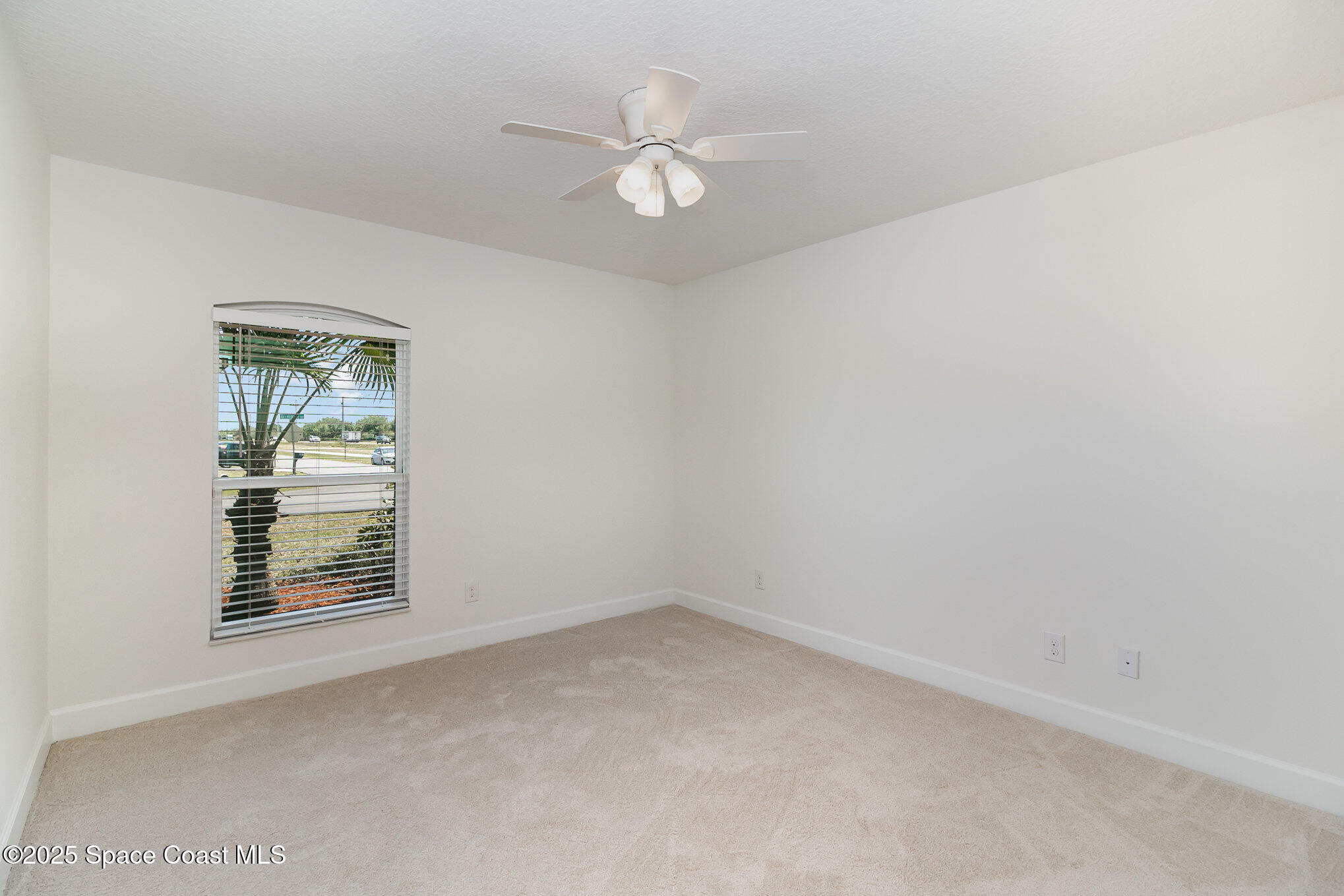 691 Belvedere Road Northwest Palm Bay, FL 32907 - Photo 13 of 26 an empty room with windows and fan